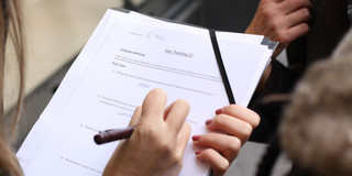 Questionnaire A woman is completing a questionnaire concerning eye tracking